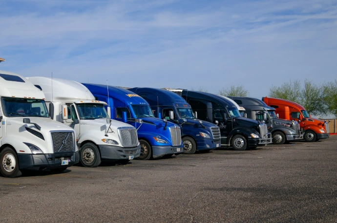 Several semi-trucks parked in a row.